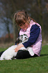kid with Coton de Tulear puppy