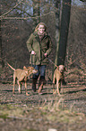 woman and 2 shorthaired Magyar Vizslas