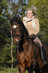 woman rides Bavarian warmblood