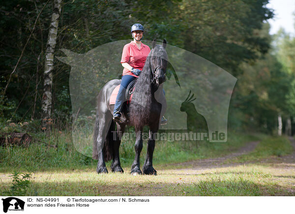 woman rides Friesian Horse / NS-04991