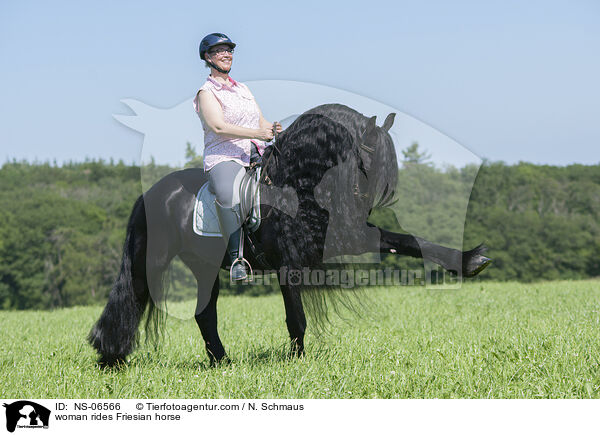 woman rides Friesian horse / NS-06566