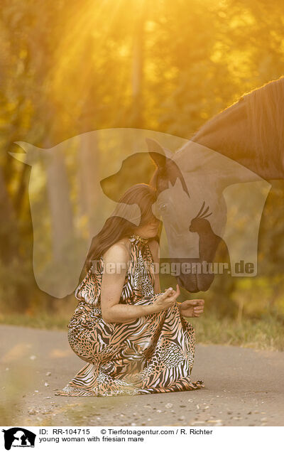 young woman with friesian mare / RR-104715
