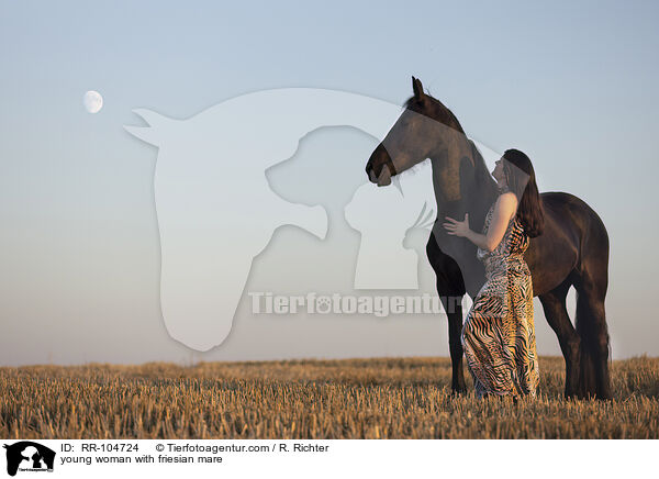 young woman with friesian mare / RR-104724