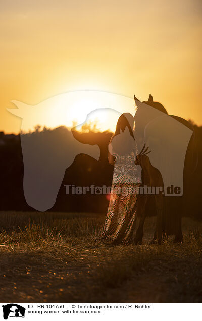 young woman with friesian mare / RR-104750