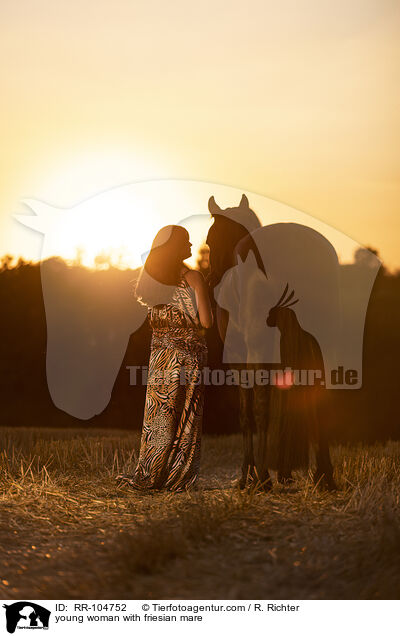 young woman with friesian mare / RR-104752