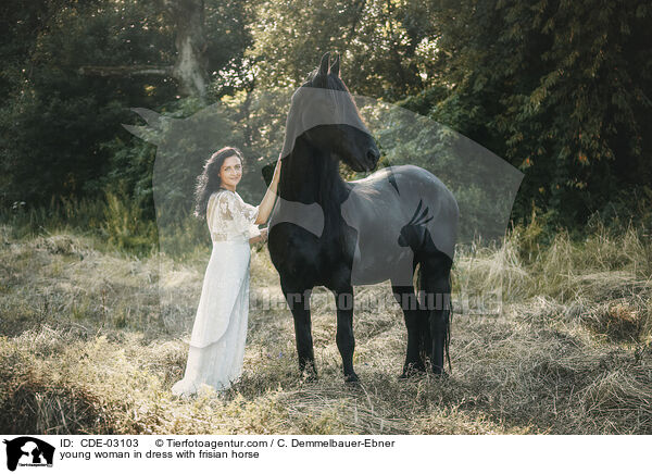 young woman in dress with frisian horse / CDE-03103