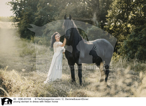 young woman in dress with frisian horse / CDE-03104