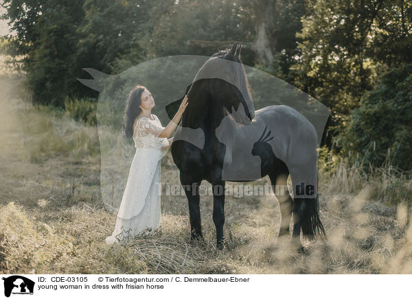 young woman in dress with frisian horse / CDE-03105