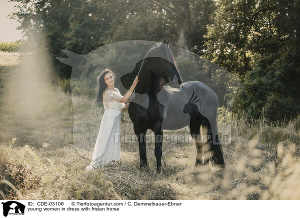 young woman in dress with frisian horse / CDE-03106