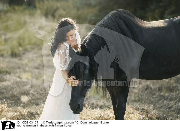young woman in dress with frisian horse / CDE-03107