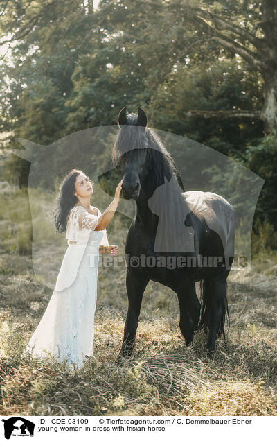 young woman in dress with frisian horse / CDE-03109