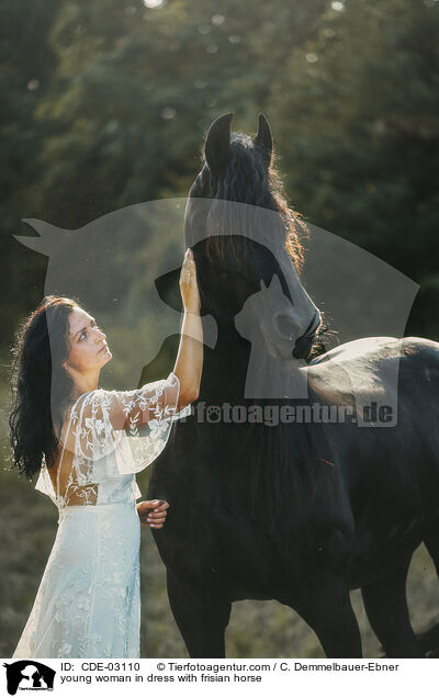 young woman in dress with frisian horse / CDE-03110