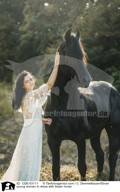 young woman in dress with frisian horse / CDE-03111