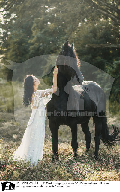 young woman in dress with frisian horse / CDE-03112