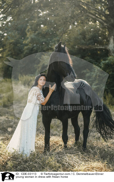 young woman in dress with frisian horse / CDE-03113
