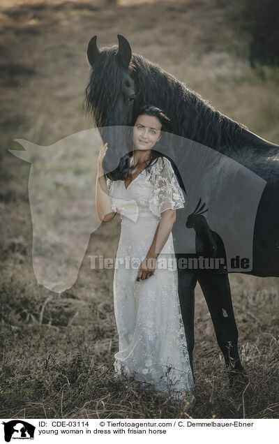 young woman in dress with frisian horse / CDE-03114