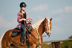 girl rides Haflinger horse