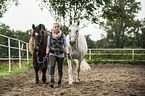 woman and 2 holstein horses