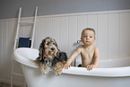 Dog and child in bathtub