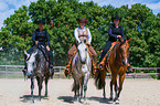 western riders with horses