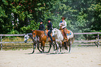 western riders with horses