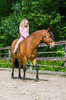 child rides Quarter Pony