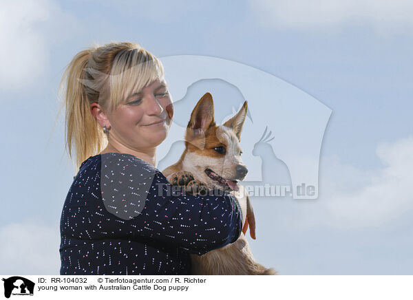 young woman with Australian Cattle Dog puppy / RR-104032