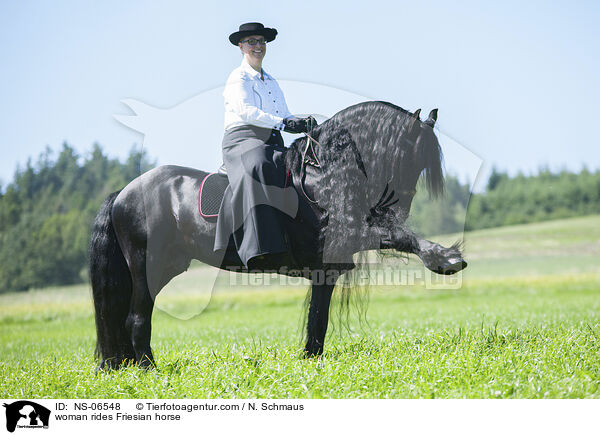 woman rides Friesian horse / NS-06548