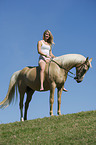 woman rides Pony mare