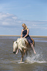 woman rides Haflinger Horse