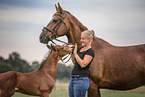 woman with Hanoverian and foal
