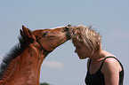 woman and Holsteiner horse foal