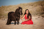 woman dand Shetland Pony