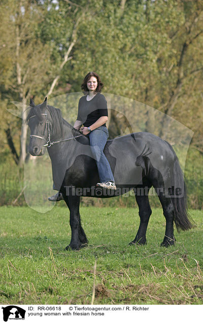 young woman with friesian horse / RR-06618