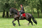 woman with friesian horse at show